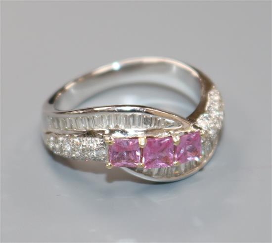 A modern white metal, diamond and pink gem set dress ring, size N.